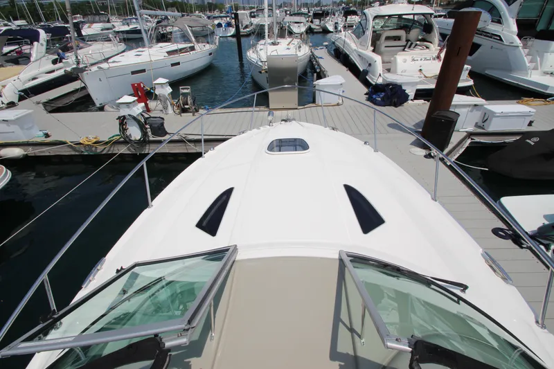 Slide: The Image of Sea Ray 330 Sundancer 2012 docked at a marina with other boats. - 21