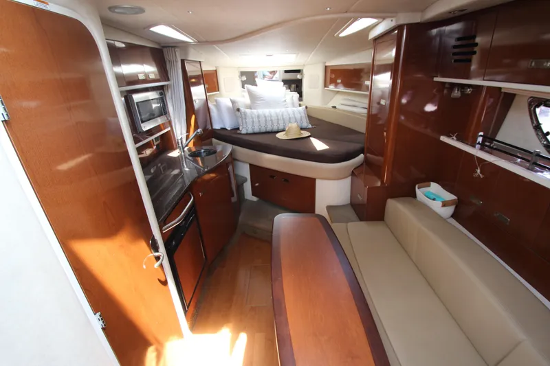 Slide: The Image of Interior of 2012 Sea Ray 330 Sundancer yacht with kitchen, seating, and bed. - 28