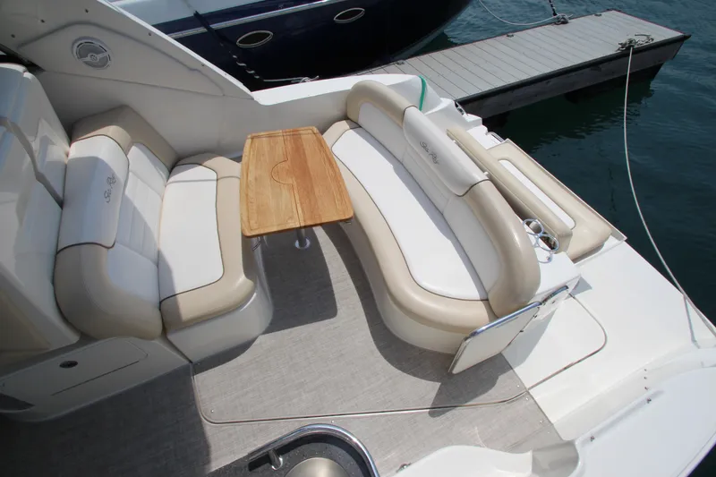 Slide: The Image of 2012 Sea Ray 330 Sundancer boat interior with seating and table. - 9