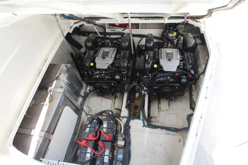Slide: The Image of The engine compartment of a 2012 Sea Ray Sundancer 330 shows two engines and batteries. - 51