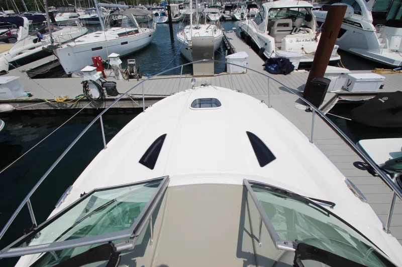 Slide: The Image of Sea Ray 330 Sundancer 2012 docked at a marina, view from the bow. - 20