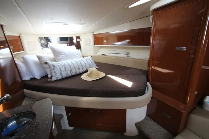 Slide: The Image of Interior cabin of 2012 Sea Ray 330 Sundancer with bed and wooden cabinetry. - 35