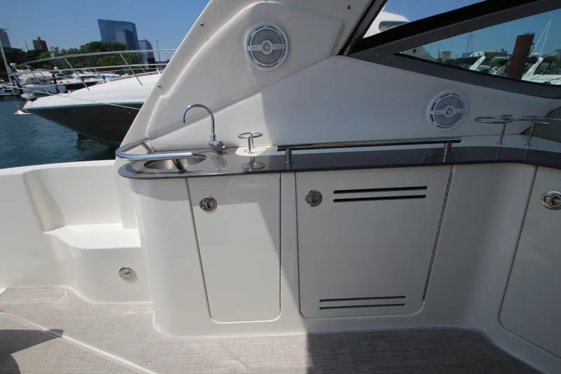 Slide: The Image of Sea Ray 330 Sundancer 2012 boat interior with sink and storage cabinets. - 25