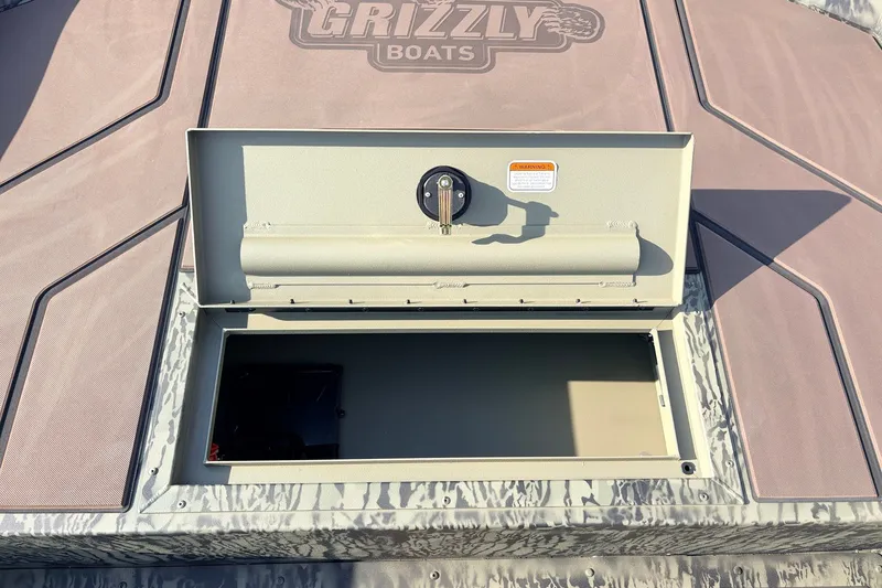 Slide: The Image of Open storage compartment on 2027 Tracker Grizzly 1860 CC boat deck. - 15