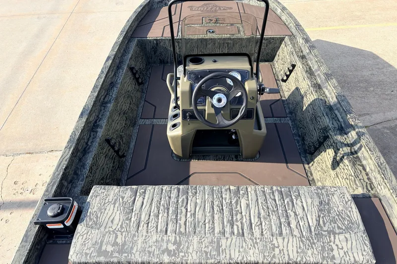 Slide: The Image of 2027 Tracker Grizzly 1860 CC boat interior with camouflage design and steering console. - 20
