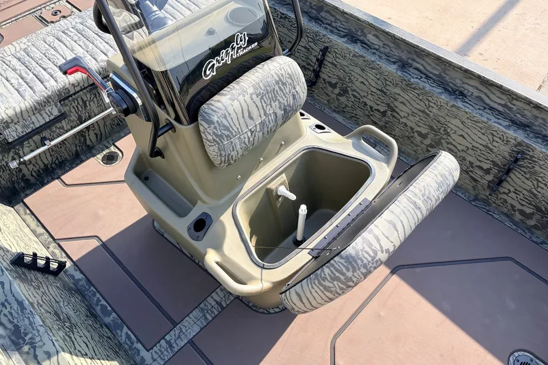 Slide: The Image of 2027 Tracker Grizzly 1860 CC boat interior with camo seating and storage compartment. - 18