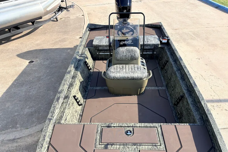 Slide: The Image of 2027 Tracker Grizzly 1860 CC boat with camouflage seating and steering console. - 16