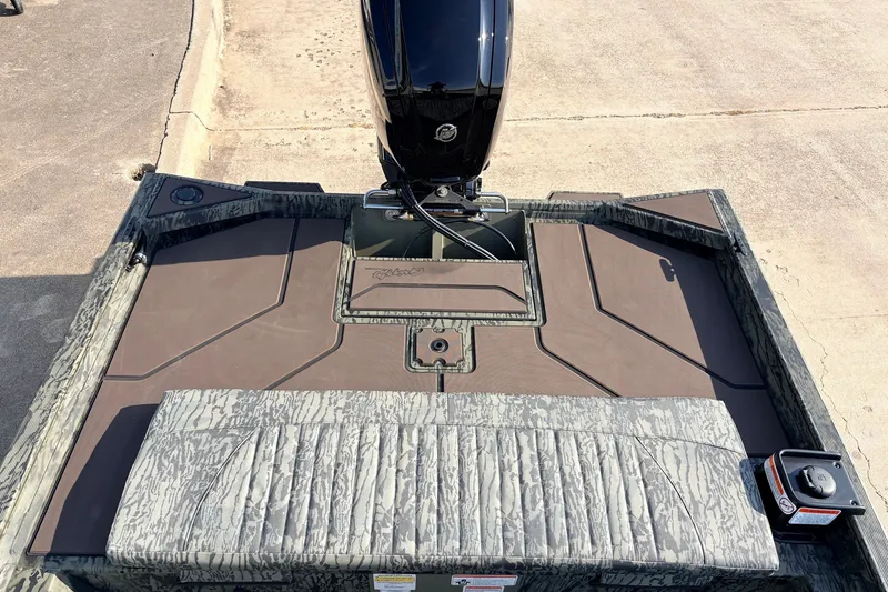 Slide: The Image of 2027 Tracker Grizzly 1860 CC boat deck with camouflage design and motor. - 24