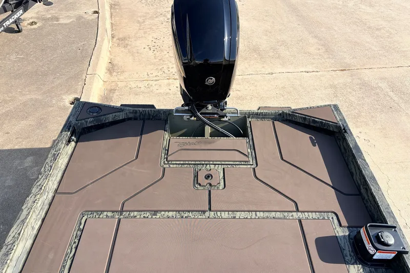 Slide: The Image of 2027 Tracker Grizzly 1860 CC boat deck with motor, featuring camo accents. - 25