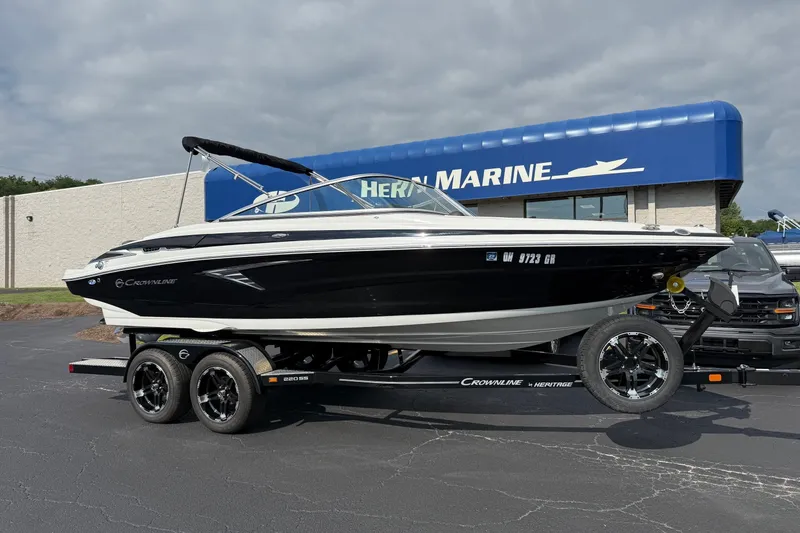 The Image of 2025 Crownline 220 SS boat on trailer at dealership, showcasing sleek design and modern features. - 0