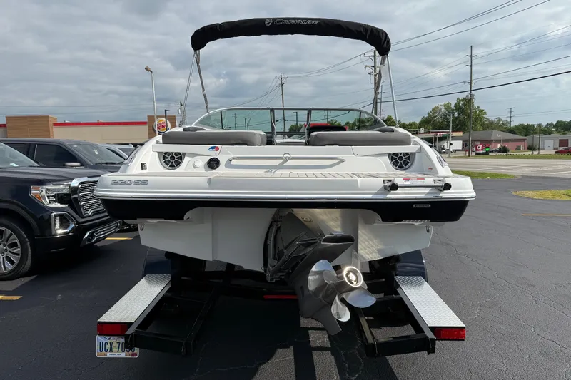 Slide: The Image of 2025 Crownline 220 SS boat on trailer in parking lot, rear view. - 13