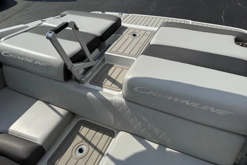 Slide: The Image of 2025 Crownline 220 SS boat interior with cushioned seating and storage compartments. - 16