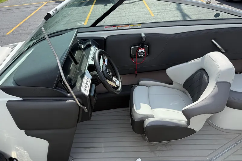Slide: The Image of Interior of a 2025 Crownline 220 SS boat, featuring a sleek dashboard and comfortable seating. - 15