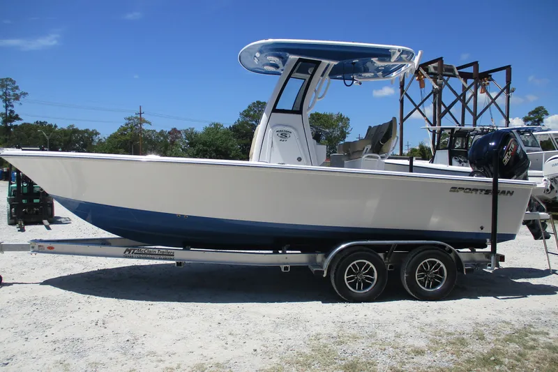 Slide: The Image of 2027 Sportsman Masters 227 Bay Boat on trailer, parked outdoors under clear blue sky. - 4
