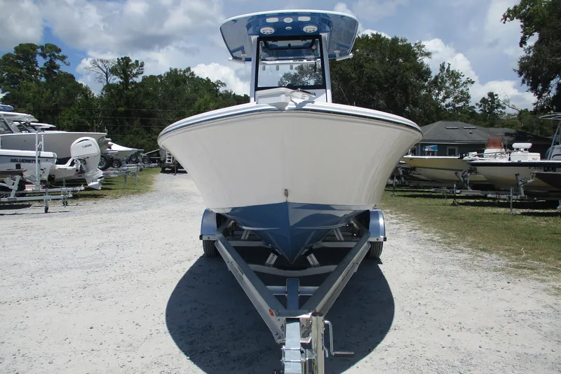 Slide: The Image of 2027 Sportsman Masters 227 Bay Boat on trailer, parked outdoors under a cloudy sky. - 2