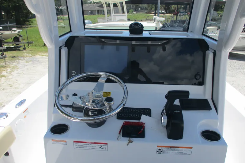 Slide: The Image of 2027 Sportsman Masters 227 Bay Boat helm with steering wheel and controls. - 10