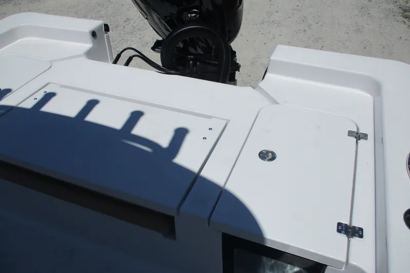 Slide: The Image of 2027 Sportsman Masters 227 Bay Boat deck with storage compartments and motor. - 13