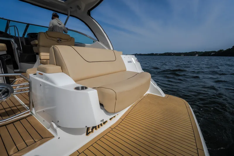 Slide: The Image of 2012 Cruisers Yachts 380 Express on water, featuring luxurious seating and sleek design. - 13
