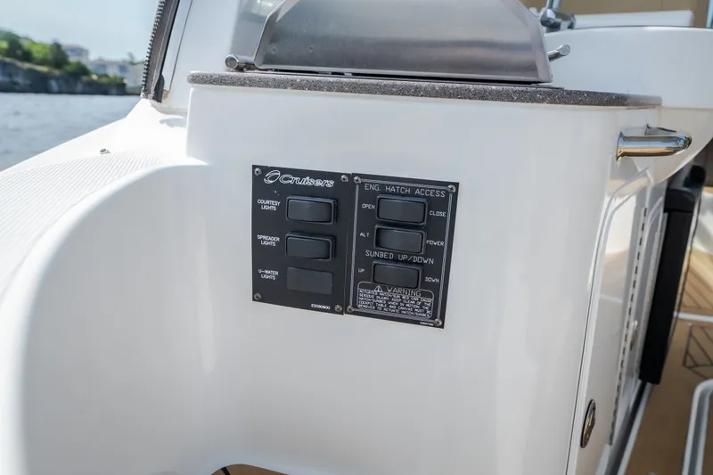 Slide: The Image of Control panel on a 2012 Cruisers Yachts 380 Express boat, featuring various switches. - 73