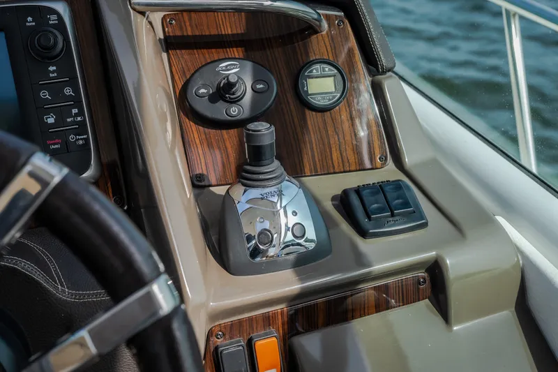 Slide: The Image of Control panel of 2012 Cruisers Yachts 380 Express with joystick and navigation controls. - 25