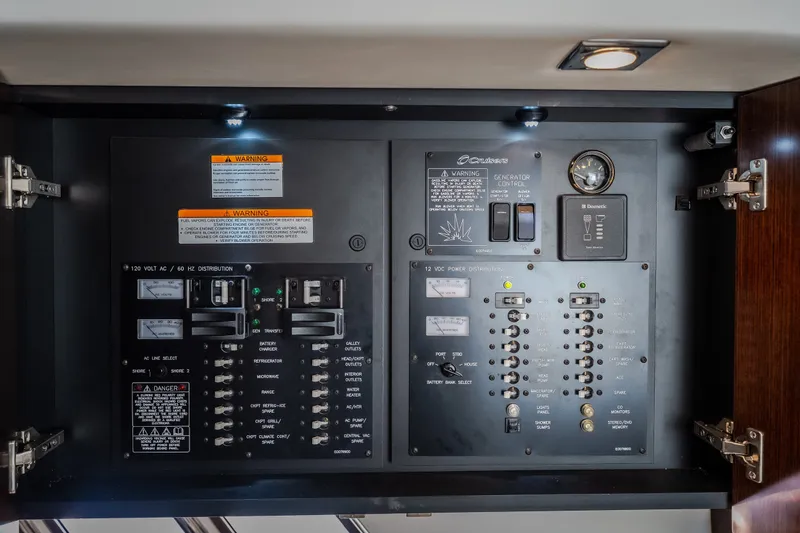 Slide: The Image of Electrical control panel of 2012 Cruisers Yachts 380 Express, featuring switches and warning labels. - 40