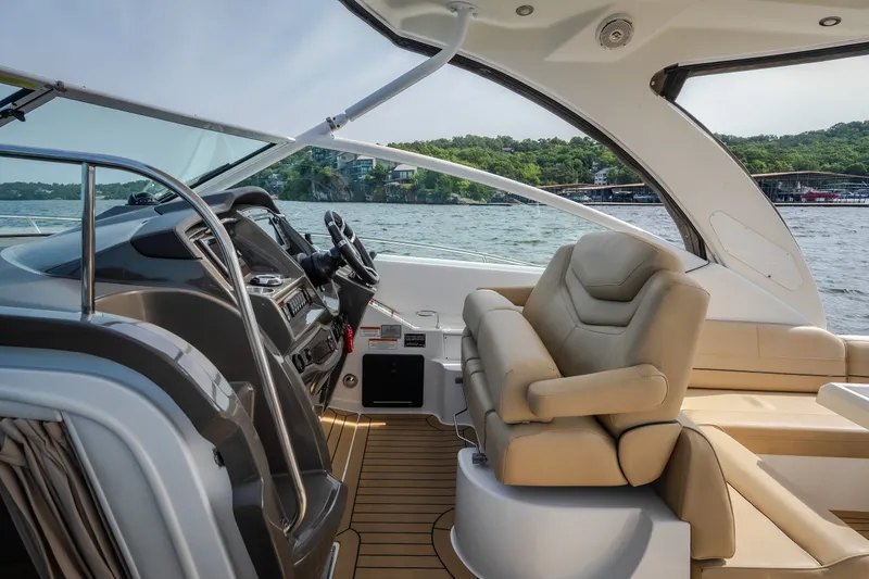 Slide: The Image of Interior of 2012 Cruisers Yachts 380 Express, featuring helm and luxurious seating. - 23