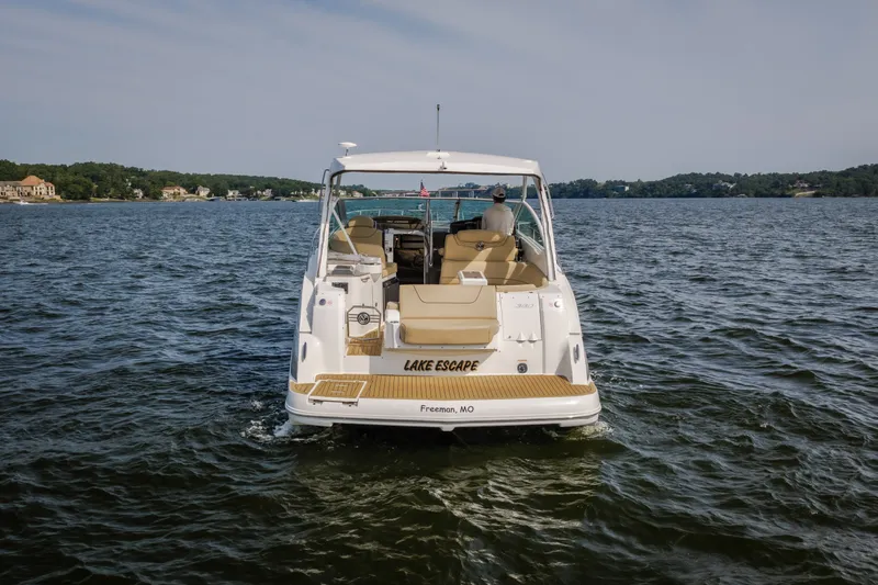 Slide: The Image of 2012 Cruisers Yachts 380 Express on a serene lake, rear view. - 19