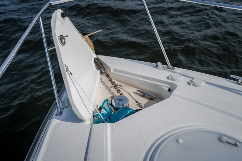 Slide: The Image of Open anchor locker on 2012 Cruisers Yachts 380 Express, showing chain and hose. - 63