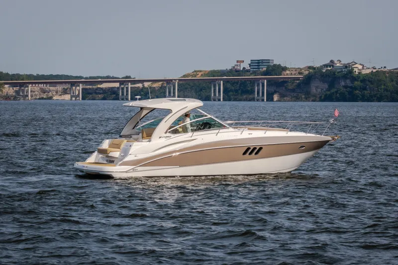 Slide: The Image of 2012 Cruisers Yachts 380 Express on water with scenic bridge background. - 12