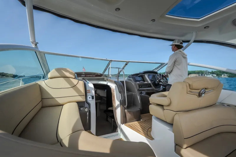 Slide: The Image of 2012 Cruisers Yachts 380 Express interior with helm, seating, and scenic water view. - 16