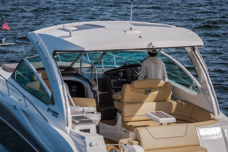 Slide: The Image of 2012 Cruisers Yachts 380 Express on water, featuring luxurious seating and modern helm. - 11