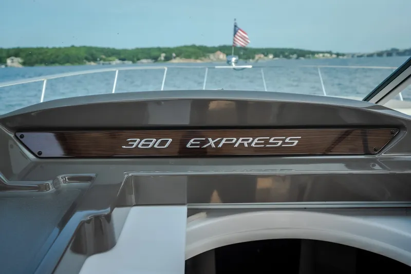 Slide: The Image of 2012 Cruisers Yachts 380 Express dashboard with lake view and American flag. - 38