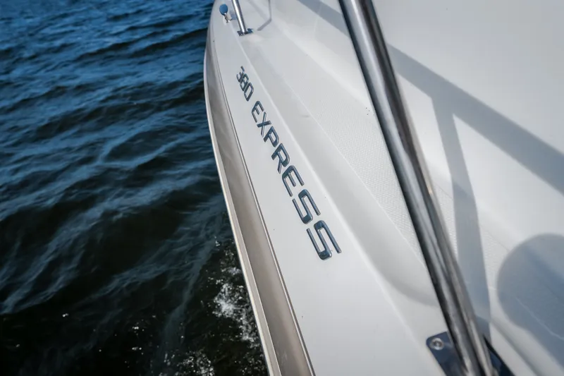 Slide: The Image of 2012 Cruisers Yachts 380 Express on water, showcasing sleek design and branding. - 61