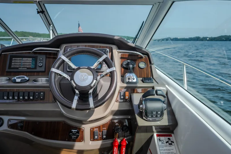Slide: The Image of Helm of 2012 Cruisers Yachts 380 Express, featuring modern controls and steering wheel. - 35