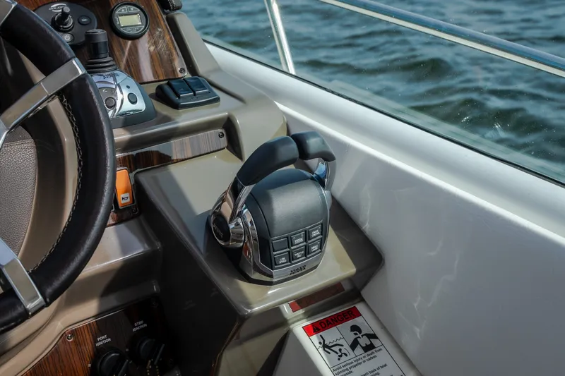 Slide: The Image of Control panel of 2012 Cruisers Yachts 380 Express with steering wheel and throttle levers. - 36