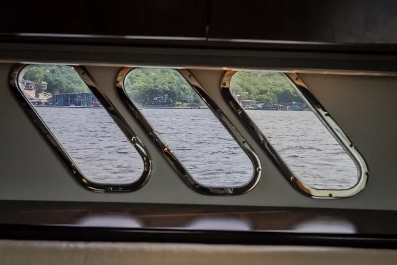 Slide: The Image of Interior view from 2012 Cruisers Yachts 380 Express, showcasing scenic water and shoreline through windows. - 42