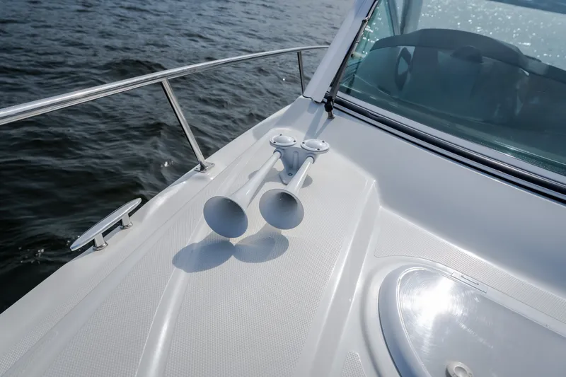 Slide: The Image of 2012 Cruisers Yachts 380 Express boat deck with dual horns on open water. - 65