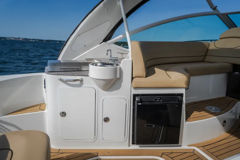 Slide: The Image of 2012 Cruisers Yachts 380 Express interior with sink, seating, and ocean view. - 29