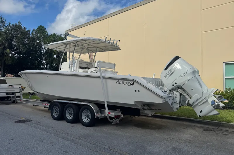 Slide: The Image of 1997 Venture 34 Center Console boat on trailer with Suzuki outboard engines. - 6