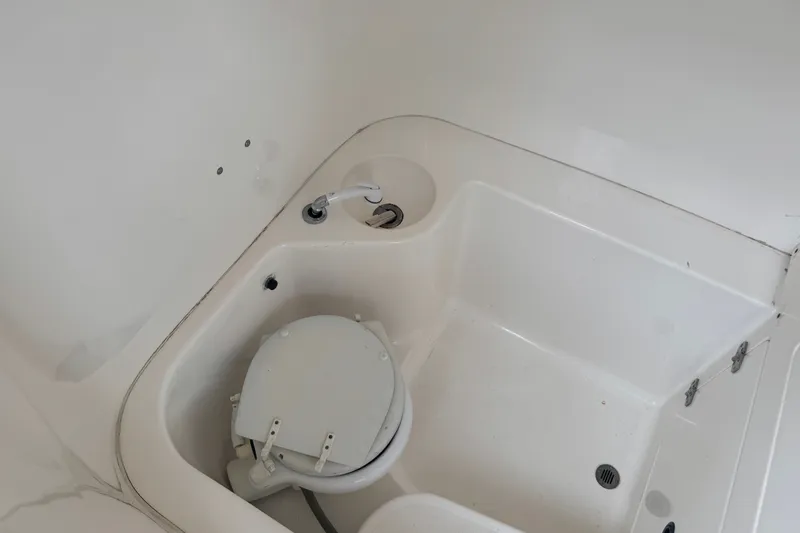 Slide: The Image of Interior of 1997 Venture 34 Center Console boat with compact marine toilet. - 30