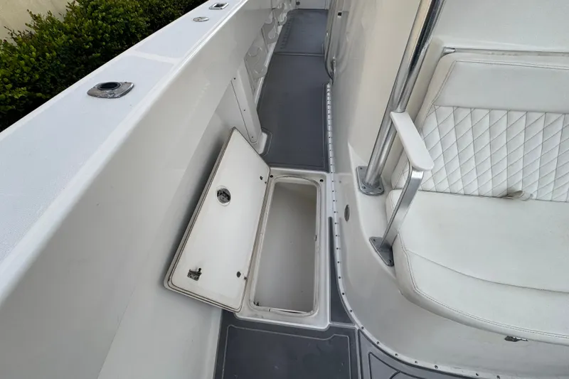 Slide: The Image of 1997 Venture 34 Center Console boat interior with open storage compartment and cushioned seating. - 20