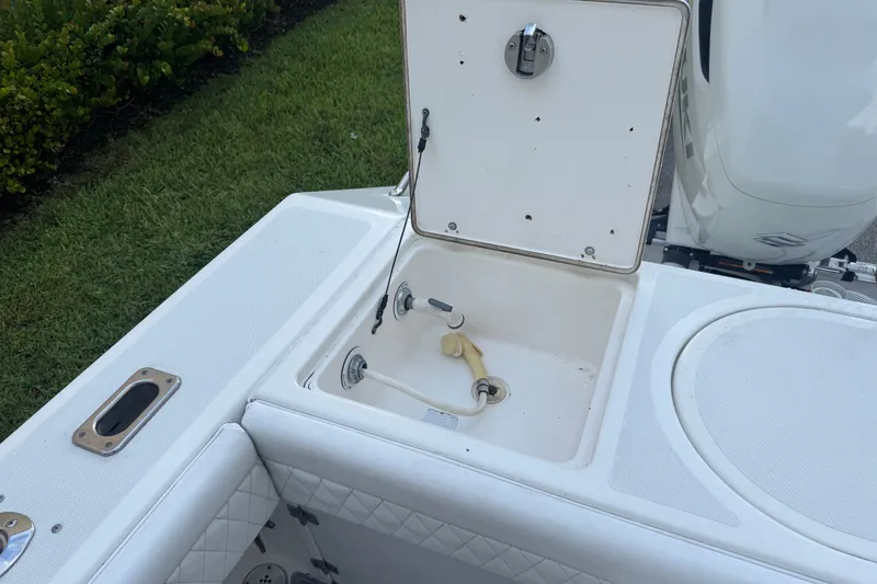Slide: The Image of Open storage compartment on a 1997 Venture 34 Center Console boat deck. - 19