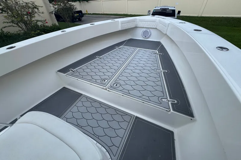 Slide: The Image of 1997 Venture 34 Center Console boat deck with patterned flooring and seating. - 17