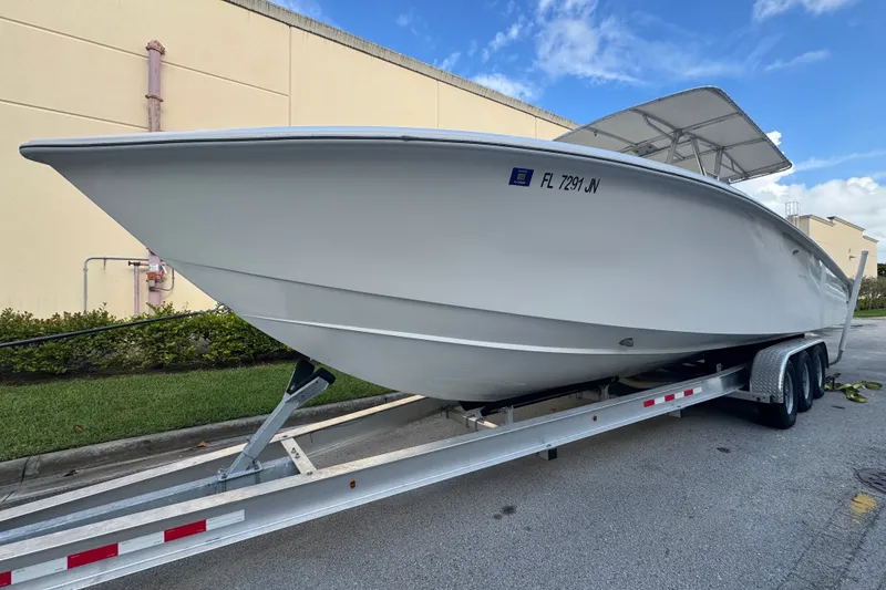 Slide: The Image of 1997 Venture 34 Center Console boat on trailer, parked outdoors. - 4