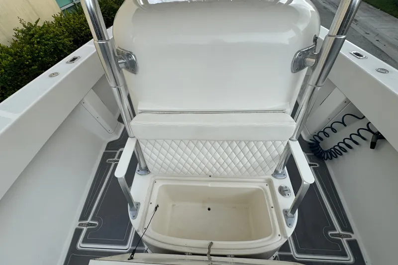 Slide: The Image of 1997 Venture 34 Center Console boat interior with white seating and storage compartment. - 28