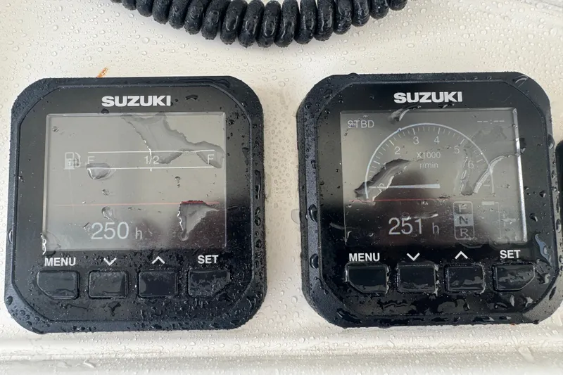 Slide: The Image of Suzuki marine gauges on a 1997 Venture 34 Center Console, displaying engine hours. - 22