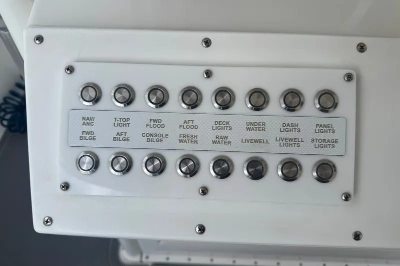 Slide: The Image of Control panel of a 1997 Venture 34 Center Console boat with labeled switches. - 35