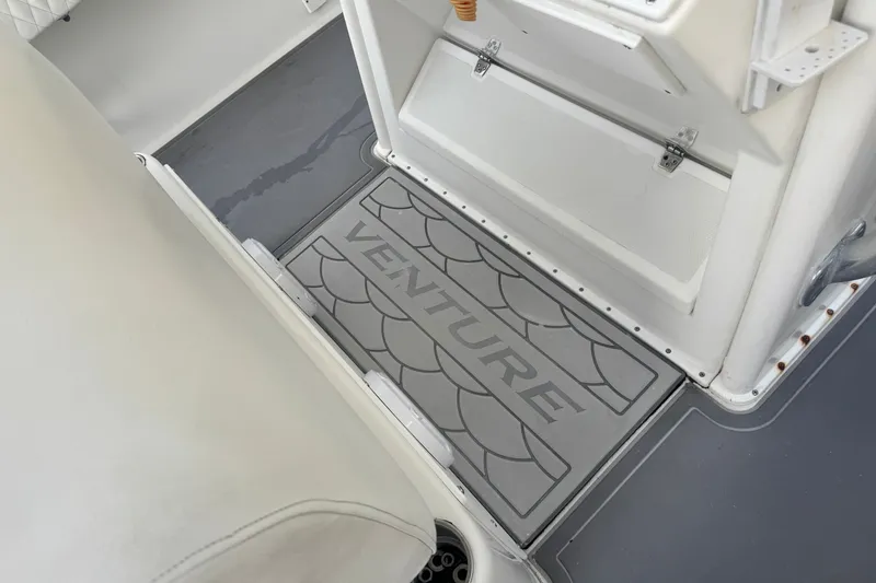 Slide: The Image of Floor mat with "Venture" logo on a 1997 Venture 34 Center Console boat. - 36