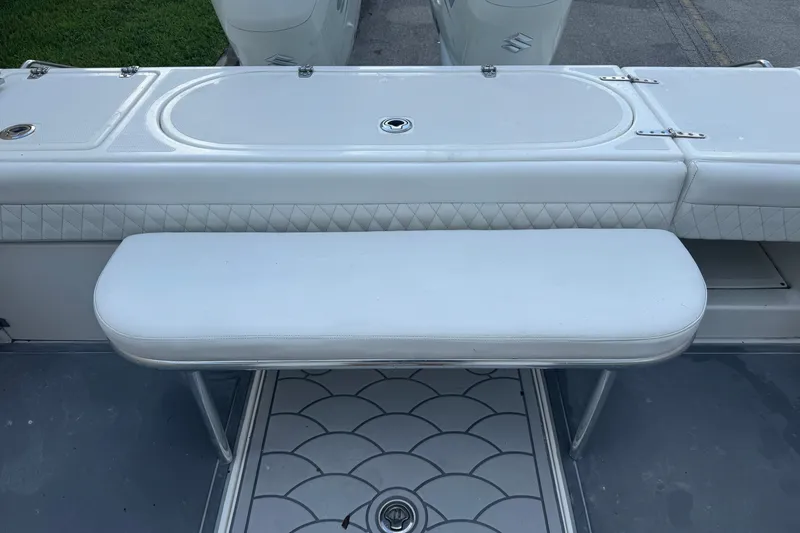 Slide: The Image of 1997 Venture 34 Center Console boat with white cushioned seating and deck details. - 34