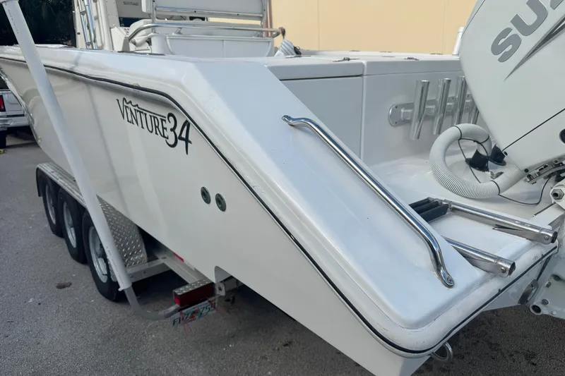 Slide: The Image of 1997 Venture 34 Center Console boat on trailer, featuring sleek design and Suzuki engine. - 11